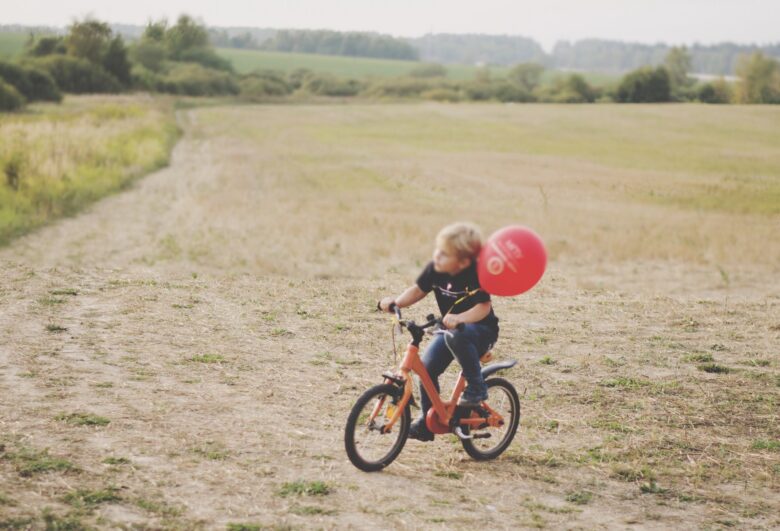 Biking bike kid fun summertime outdoor activities sports countryside orange